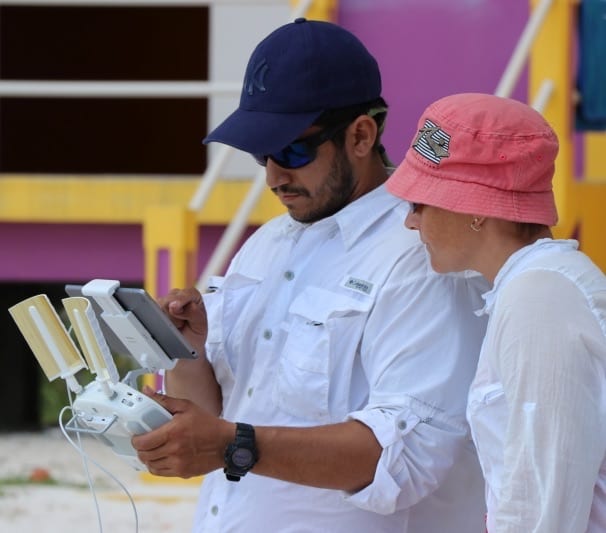 Two people looking at a remote controller to learn to capture drone data