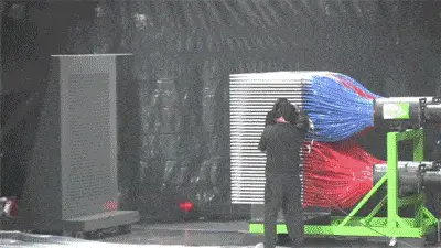 Person interacting with colorful mechanical equipment.