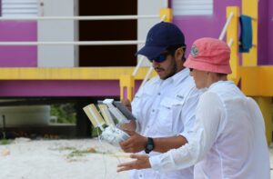 Two people with a remote controller to learn drone mapping