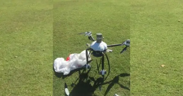 Drone on grass with debris nearby.