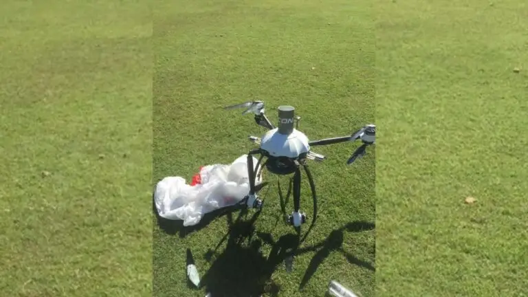 Drone on grass with debris nearby.