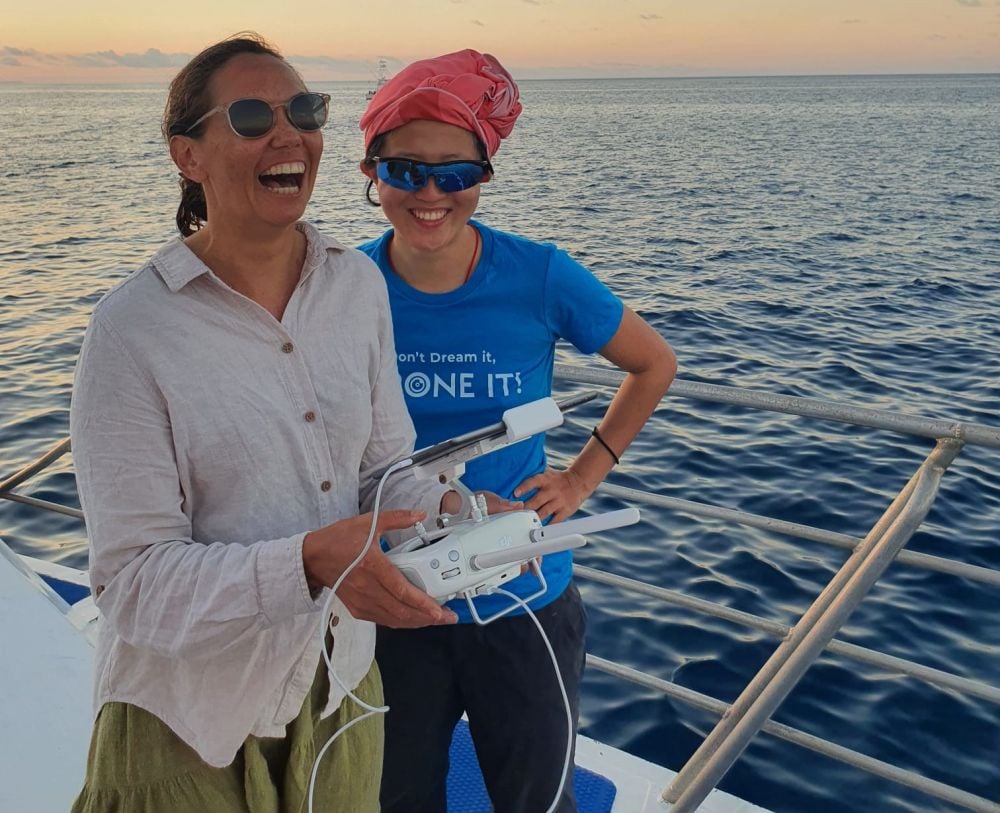 Two women on a boat to capture drone mapping data