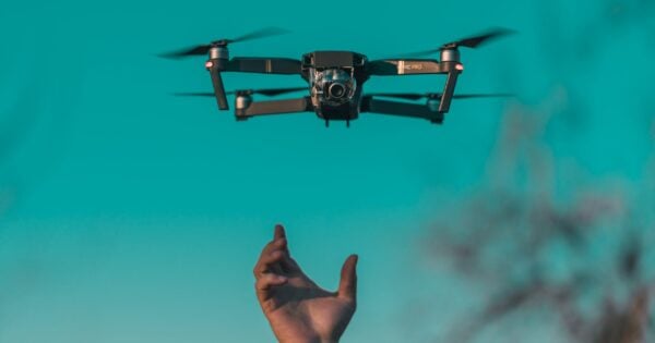 Drone hovering above a person's outstretched hand.