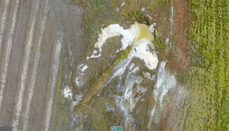 Aerial view of uneven farmland with patches.