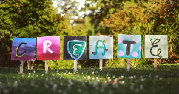 Colourful painted signs spelling 'CREATE' outdoors