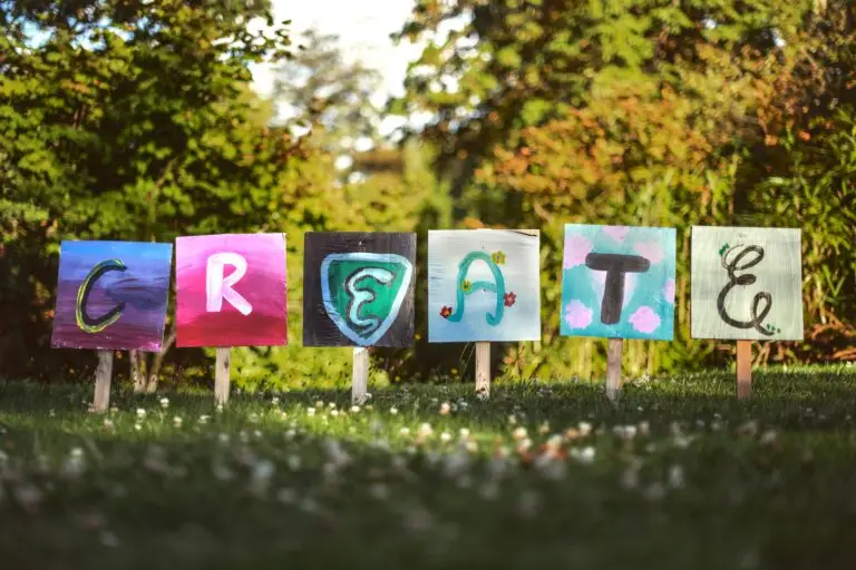 Colourful painted signs spelling 'CREATE' outdoors