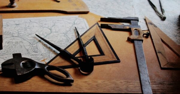 Vintage drafting tools on a wooden table