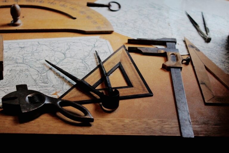 Vintage drafting tools on a wooden table