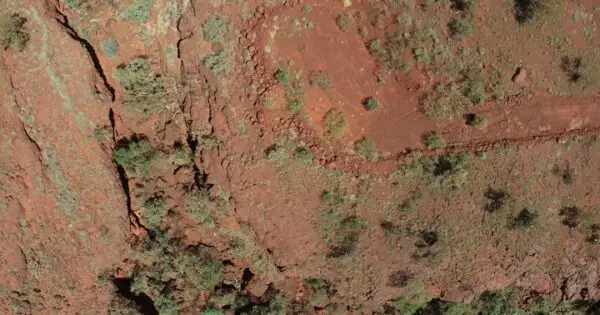 Aerial view of red earth with sparse vegetation.