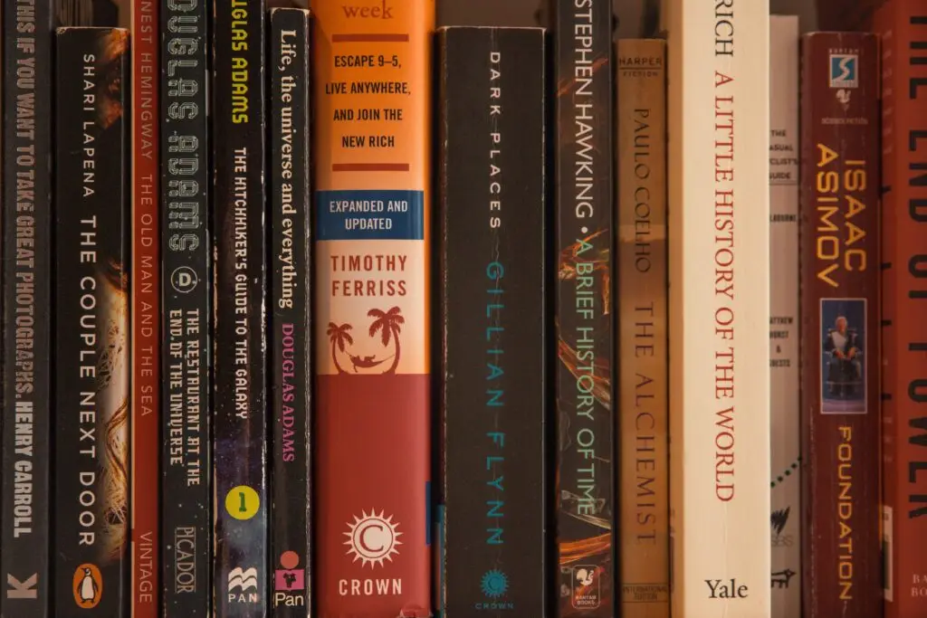 Collection of diverse books on a shelf.