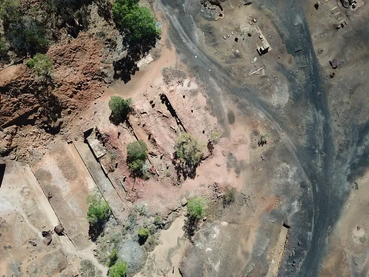 Aerial view of rocky terrain with vegetation.