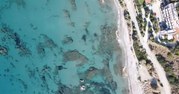 Aerial view of turquoise water and coastline.