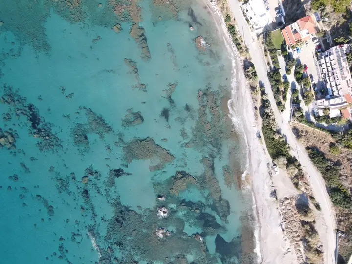 Aerial view of turquoise water and coastline.