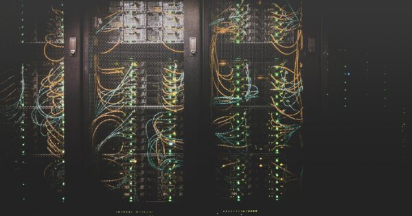 Close-up of illuminated server racks and cables