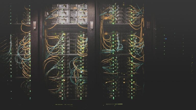 Close-up of illuminated server racks and cables