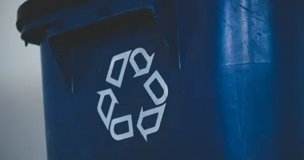 Blue recycling bin with recycling symbol.