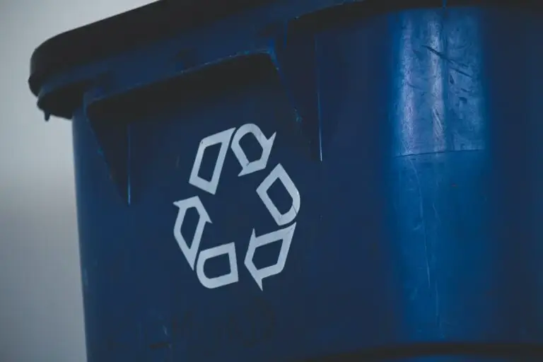Blue recycling bin with recycling symbol.