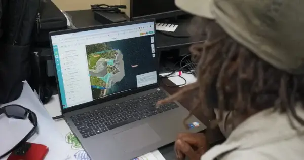 Person analyzing map on a laptop