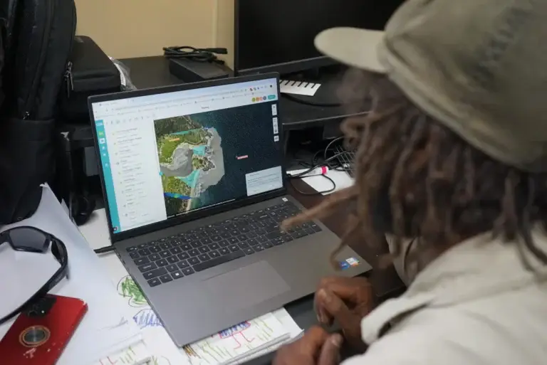 Person analyzing map on a laptop