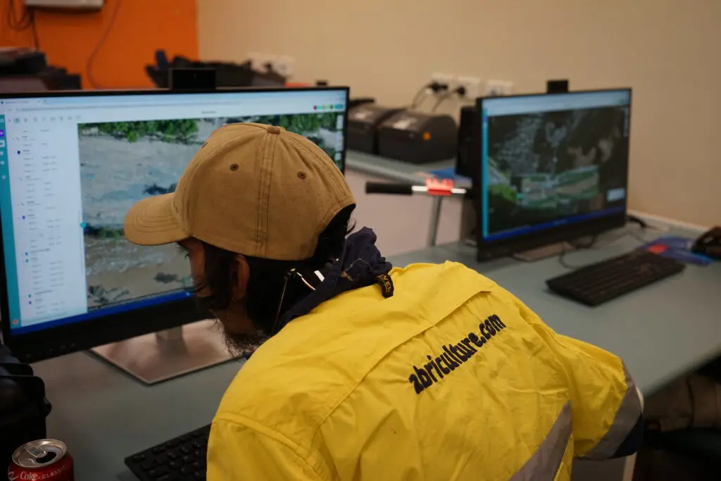 Worker analysing data on computer screens.